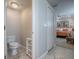A bathroom with a toilet and a view into a bedroom with a queen size bed at 3775 Brantley Place Cir, Apopka, FL 32703