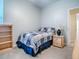 Small bedroom featuring a twin bed, bookcase, nightstand and carpeted floor at 3775 Brantley Place Cir, Apopka, FL 32703