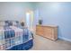 Cozy bedroom showcases a bed, dresser, and a glimpse into the bath at 3775 Brantley Place Cir, Apopka, FL 32703