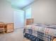 Small bedroom featuring a twin bed, closet, desk, and carpeted floor at 3775 Brantley Place Cir, Apopka, FL 32703