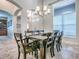 Open dining room with an elegant chandelier, and views of other living spaces at 3775 Brantley Place Cir, Apopka, FL 32703