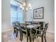 Elegant dining room with dark wood table, seating for eight, and stylish chandelier at 3775 Brantley Place Cir, Apopka, FL 32703