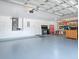 Spacious garage with epoxy flooring, ample storage cabinets, and work bench area for projects at 3775 Brantley Place Cir, Apopka, FL 32703