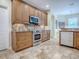 Well-equipped kitchen with custom cabinetry, stainless appliances, and tiled backsplash at 3775 Brantley Place Cir, Apopka, FL 32703