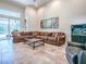 Spacious living room with a large sectional sofa, fish tank, and tile floors at 3775 Brantley Place Cir, Apopka, FL 32703