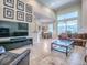 Open-concept living room boasts tile floors, plenty of natural light, and backyard views at 3775 Brantley Place Cir, Apopka, FL 32703