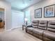 Living room featuring a sofa, window, closet, and carpeted floor at 3775 Brantley Place Cir, Apopka, FL 32703