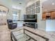 Bright living room featuring tile floors, high ceilings, and an open layout into dining and kitchen areas at 3775 Brantley Place Cir, Apopka, FL 32703