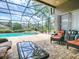 Screened-in patio with brick floors, comfortable seating, and views of the pool and backyard at 3775 Brantley Place Cir, Apopka, FL 32703