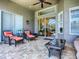 Cozy outdoor patio featuring brick flooring, comfortable seating, and a view into the home at 3775 Brantley Place Cir, Apopka, FL 32703