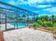 Landscaped outdoor space with screened-in pool, spa, and paver patio at 3775 Brantley Place Cir, Apopka, FL 32703