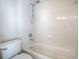 All-white shower and tub are with white ceramic tiles and silver shower head and faucet fixtures at 3775 Brantley Place Cir, Apopka, FL 32703