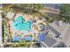 Features a resort style pool area with lounge chairs, spa, covered seating, and palm trees at 3842 Beacon Ridge Way, Clermont, FL 34711