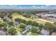 Features a residential neighborhood adjacent to a golf course and community buildings in distance at 3842 Beacon Ridge Way, Clermont, FL 34711