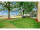 Private backyard featuring manicured lawn and mature trees at 3842 Beacon Ridge Way, Clermont, FL 34711
