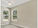 Bright bedroom with wood-look floors and two windows at 3842 Beacon Ridge Way, Clermont, FL 34711