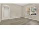 Comfortable bedroom with a large window providing natural light and hardwood floors at 3842 Beacon Ridge Way, Clermont, FL 34711