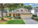 Inviting single-Gathering home featuring manicured landscaping and an attached two-car garage at 3842 Beacon Ridge Way, Clermont, FL 34711