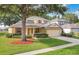 Lovely single-Gathering home boasts a lush front lawn and a convenient two-car garage at 3842 Beacon Ridge Way, Clermont, FL 34711