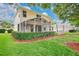 Two-story home boasting an outdoor screened in patio and a yard with garden at 3842 Beacon Ridge Way, Clermont, FL 34711