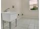 Laundry room with utility sink and natural light at 3842 Beacon Ridge Way, Clermont, FL 34711