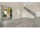 Spacious living area with a staircase, access to a patio, and stylish hardwood floors at 3842 Beacon Ridge Way, Clermont, FL 34711