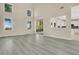 Open-concept living room with views to the kitchen, sliding glass doors, and hardwood floors at 3842 Beacon Ridge Way, Clermont, FL 34711