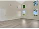 Bright living room with soaring ceilings, large windows, and modern flooring at 3842 Beacon Ridge Way, Clermont, FL 34711