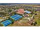 Birds-eye view highlights community tennis courts, pool, clubhouse, and surrounding neighborhood at 3948 Serena Ln, Clermont, FL 34711