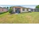 The backyard features a well-maintained lawn leading to a screened patio, ideal for outdoor relaxation and gatherings at 3948 Serena Ln, Clermont, FL 34711