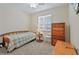Comfortable secondary bedroom with a twin bed and ample natural light at 3948 Serena Ln, Clermont, FL 34711