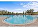 Large community pool surrounded by lounge chairs and lush greenery for relaxation and recreation at 3948 Serena Ln, Clermont, FL 34711