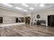 Spacious fitness center featuring hardwood floors, mirrored wall, television, and complete set of weights and equipment at 3948 Serena Ln, Clermont, FL 34711