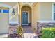 Close-up of front door entrance with brick pathway and stone accents on columns at 3948 Serena Ln, Clermont, FL 34711