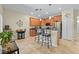 Charming kitchen with wood cabinets, stainless appliances, breakfast bar and stylish pendant lighting at 3948 Serena Ln, Clermont, FL 34711