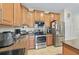 Well-equipped kitchen with stainless steel appliances and adjacent countertop food preparation area at 3948 Serena Ln, Clermont, FL 34711