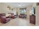 Living room with neutral walls, tile floors, leather seating, and a large window at 3948 Serena Ln, Clermont, FL 34711