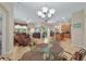 Bright open-plan living space with modern furnishings, chandelier, and seamless flow into the kitchen at 3948 Serena Ln, Clermont, FL 34711