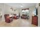 Spacious living room with neutral walls, tile floors, and comfortable leather seating at 3948 Serena Ln, Clermont, FL 34711