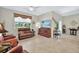 Living room with a TV, sliding glass doors, neutral walls, and tile floors at 3948 Serena Ln, Clermont, FL 34711