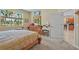 Cozy main bedroom with natural light, carpet flooring, a large window, and an ensuite bathroom at 3948 Serena Ln, Clermont, FL 34711