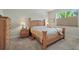 Cozy main bedroom featuring neutral tones, plush carpeting, and a large window for natural light at 3948 Serena Ln, Clermont, FL 34711