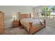 Cozy main bedroom featuring neutral tones, plush carpeting, and a large window for natural light at 3948 Serena Ln, Clermont, FL 34711