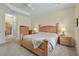 Relaxing main bedroom featuring a wooden bed frame and neutral color palette at 3948 Serena Ln, Clermont, FL 34711