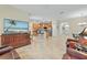Open floor plan with a kitchen, living room, and dining area, showcasing tile floors at 3948 Serena Ln, Clermont, FL 34711