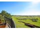 Breathtaking outdoor view from the balcony, showcasing a verdant landscape and distant lake at 3948 Serena Ln, Clermont, FL 34711