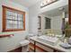 Bright bathroom featuring white sink and vanity, a modern mirror and an adjacent toilet at 41513 Aspen St, Eustis, FL 32736