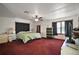 Spacious bedroom with red carpet, a green bedspread, and ample closet space at 41513 Aspen St, Eustis, FL 32736