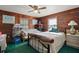Cozy bedroom with knotty pine walls and ceiling fan at 41513 Aspen St, Eustis, FL 32736