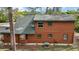Side exterior view of a log cabin with a green roof at 41513 Aspen St, Eustis, FL 32736